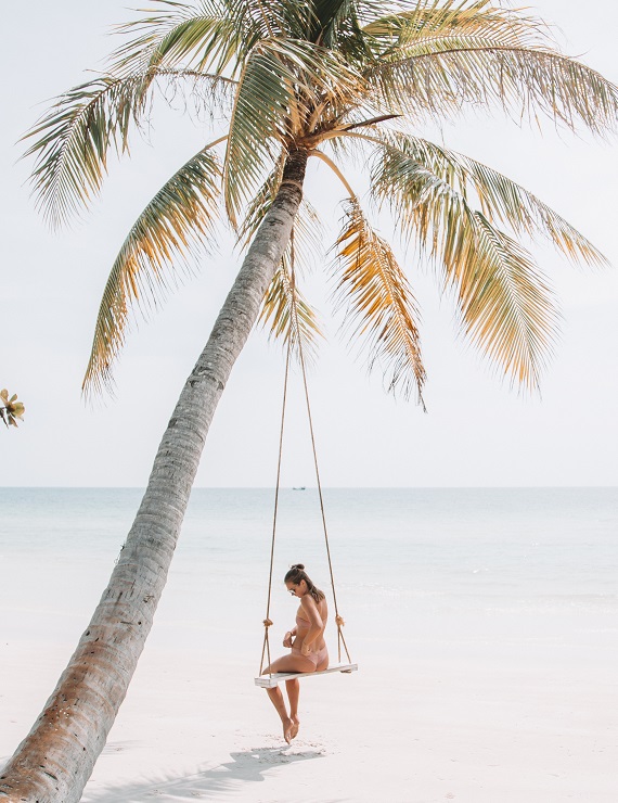 woman wearing bikini on a swing