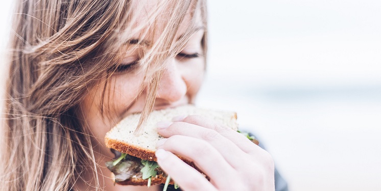 woman eating healthy sandwich